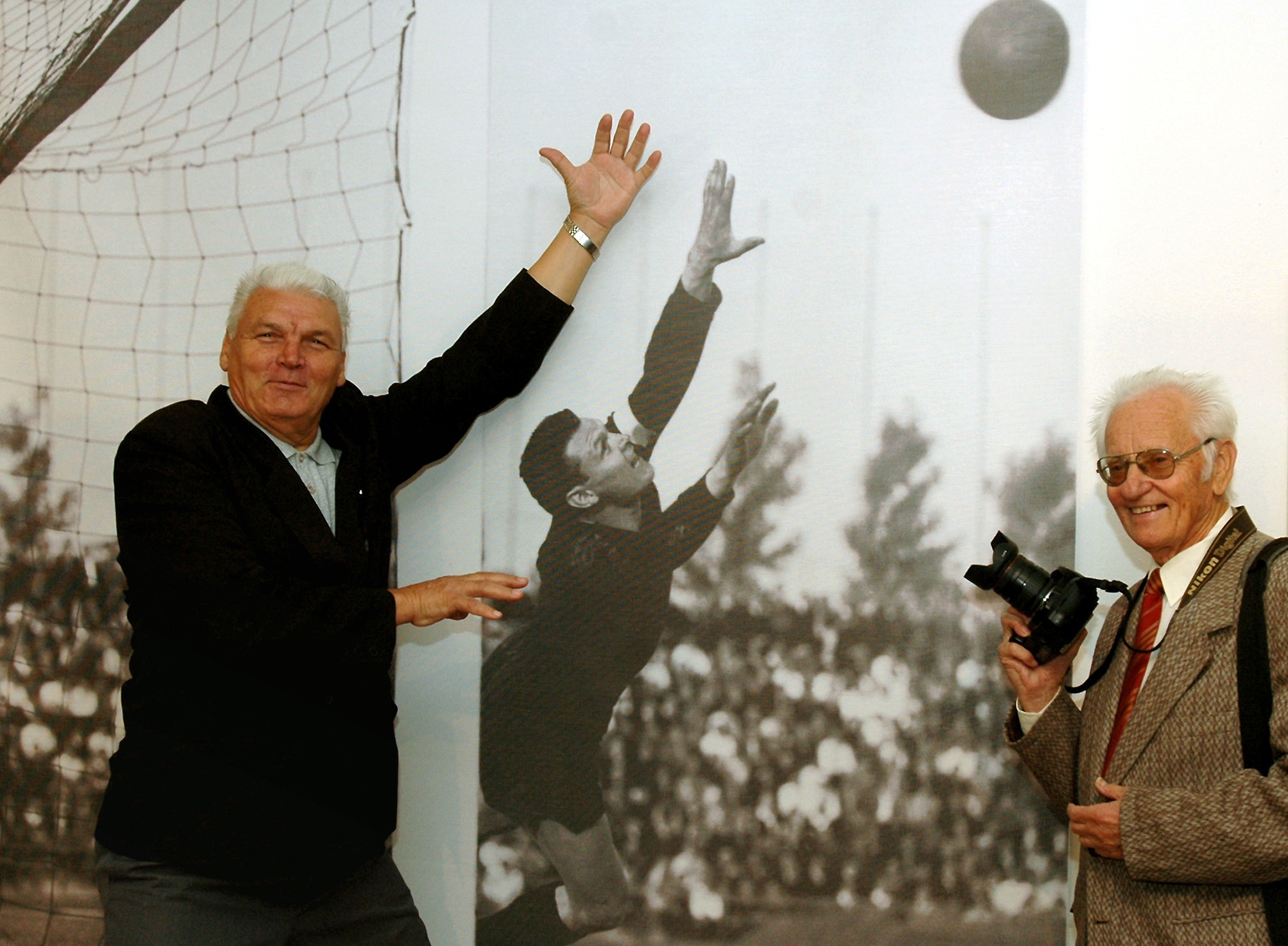 Na snímke vľavo Anton Švajlen pózuje pred vlastnou fotografiou z r. 1968, vpravo autor fotografie, športový fotoreportér R. Berenhaut.